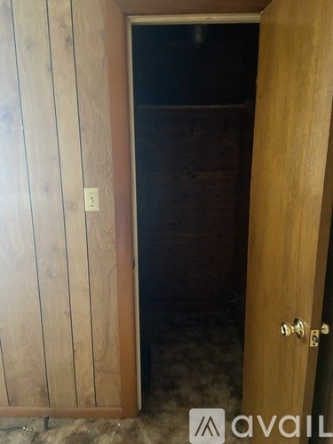 A wooden door with a brass handle and a number 2 on the wall.