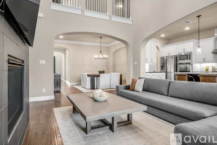 A modern living room with a grey sofa and a wooden coffee table.