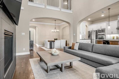 A modern living room with a grey sofa and a wooden coffee table.