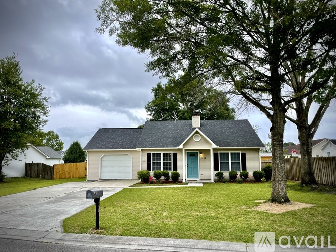 A house with a blue door and a mailbox in front.