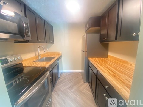 A kitchen with wooden countertops and stainless steel appliances.