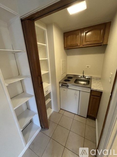A small kitchen with white appliances and wooden cabinets.