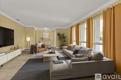 A living room with a grey couch and a television.