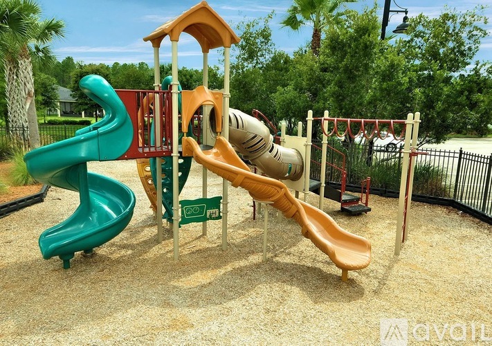 A playground with a green and a yellow slide.