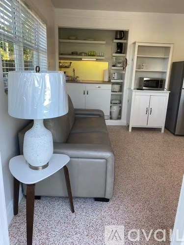 A lamp sits on a table in a living room.