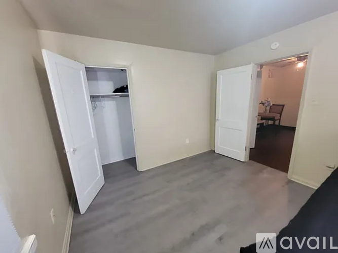 A kitchen with a black stove top oven, a black microwave, a white refrigerator, and a white sink.