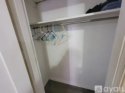 A bedroom with a bed, a wardrobe, and a desk.