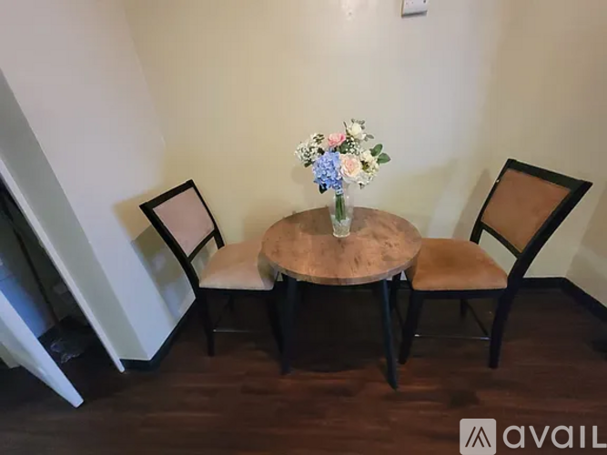 A bathroom with a toilet, sink, and shower curtain.