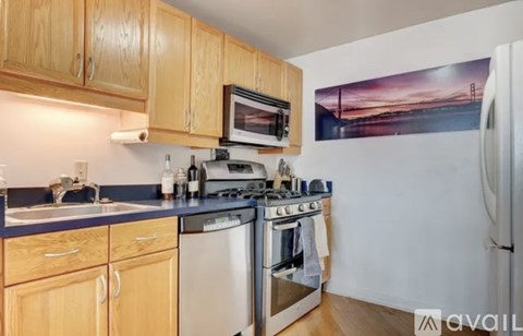 A kitchen with wooden cabinets and a stove top oven.