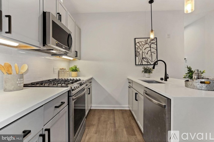 A modern kitchen with a stainless steel oven and a white countertop.