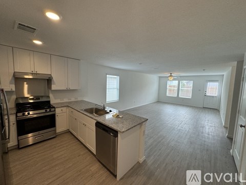 A kitchen with a stainless steel oven and a sink.