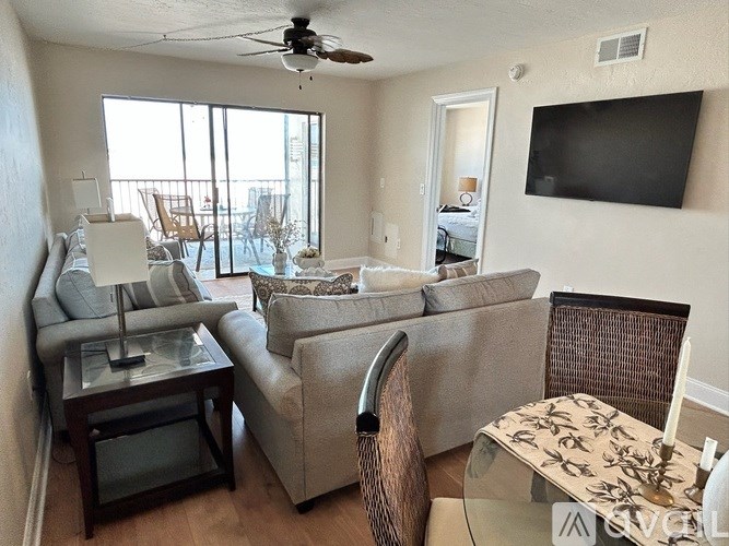 A living room with a couch, chair, and television.