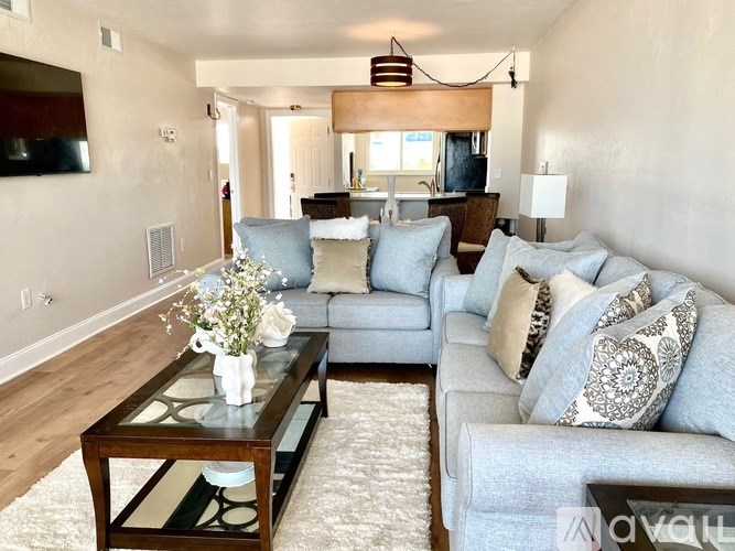 A living room with a grey couch and a coffee table.
