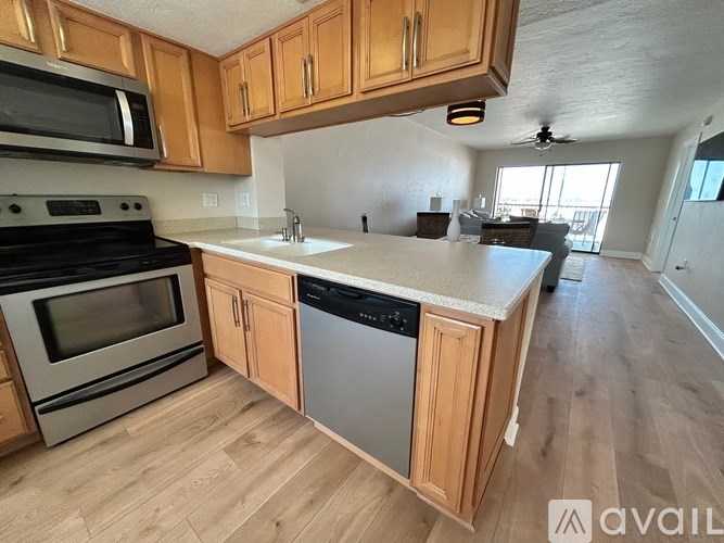 A kitchen with wooden cabinets and a white countertop.