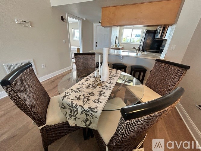 A dining room with a round table and chairs.