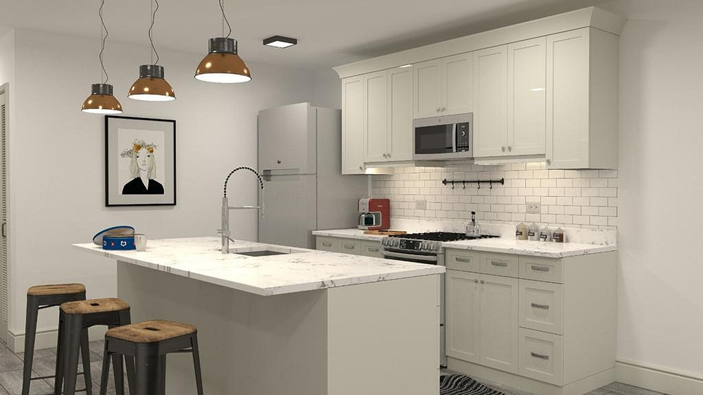 A kitchen with white cabinets and a white counter top.