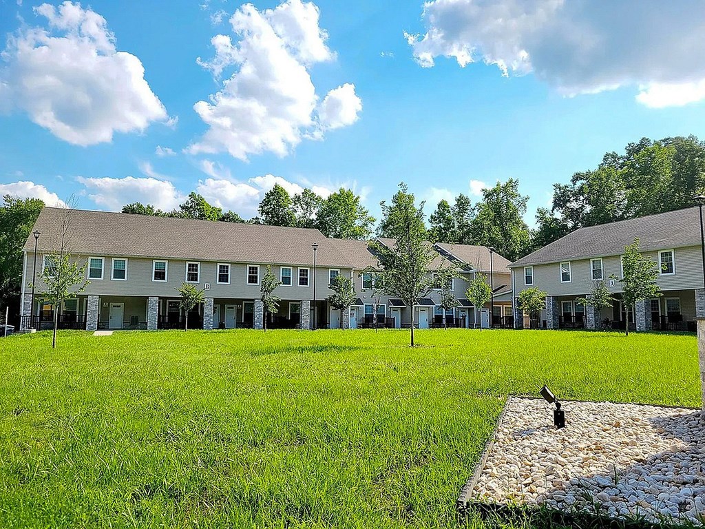 A grassy field with a building in the background.