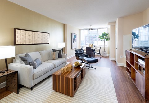 A living room with a couch, chairs, and a coffee table.