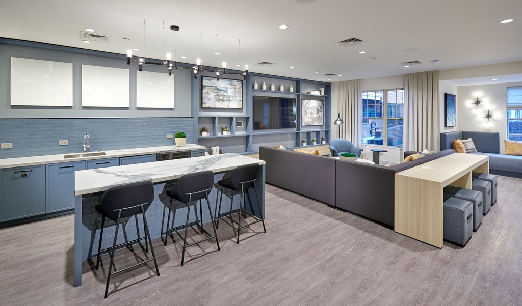 A modern kitchen with a bar area and seating.
