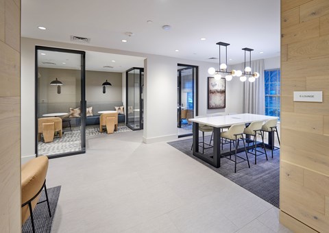 A conference room with a long table and chairs.