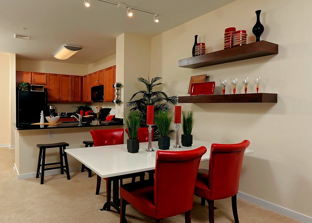 A kitchen with a table and chairs.