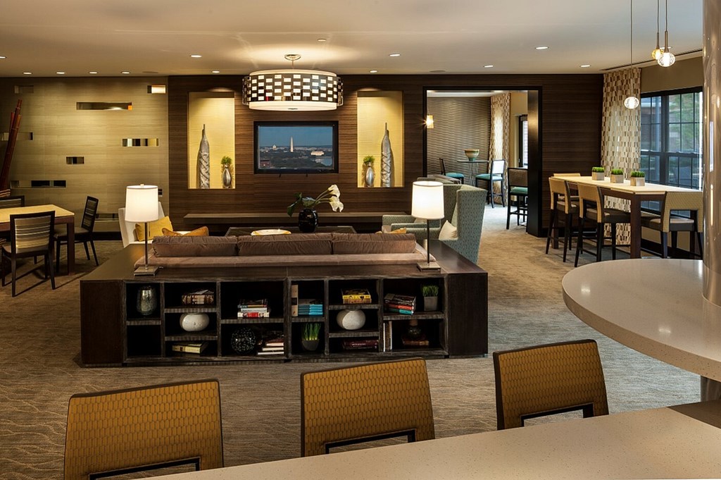 A modern living room with a large entertainment center and a flat screen TV.