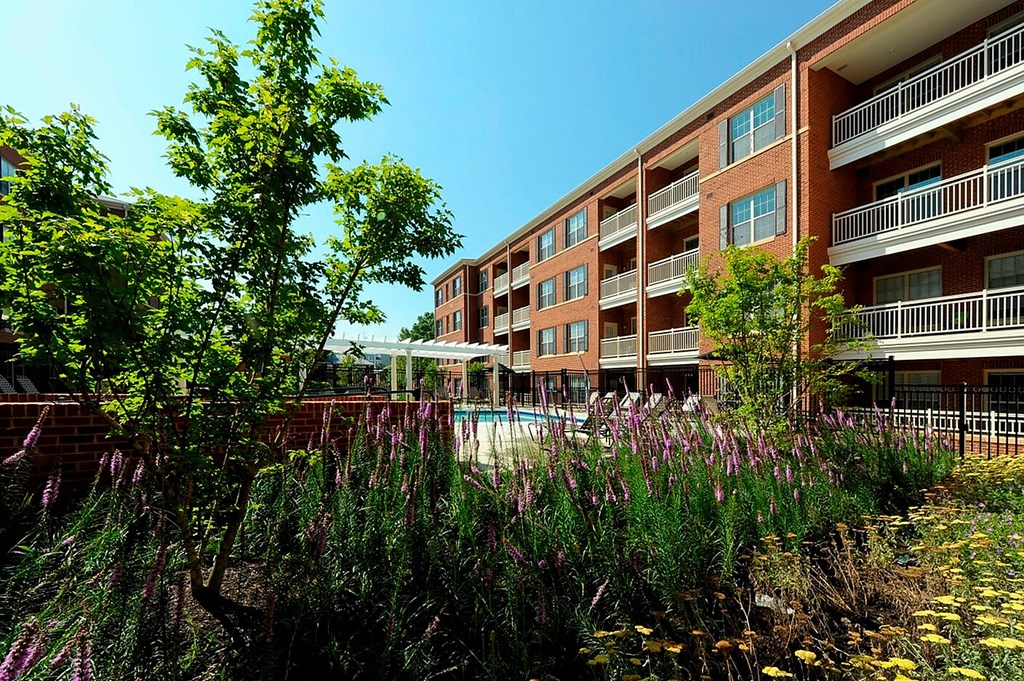 A building with a pool in front of it.