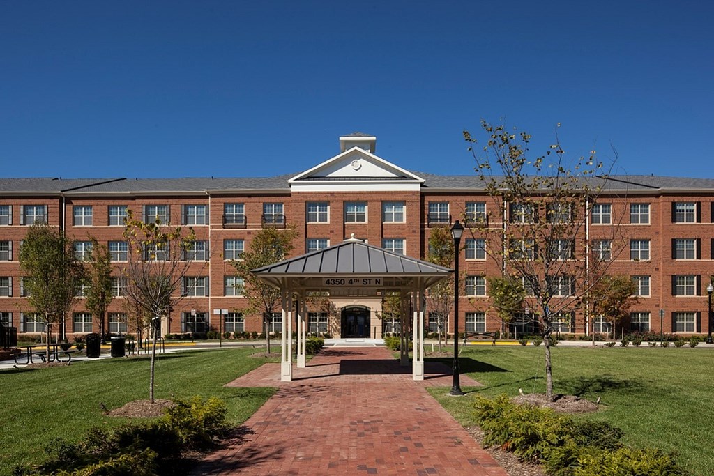 A large brick building with a gazebo in front.