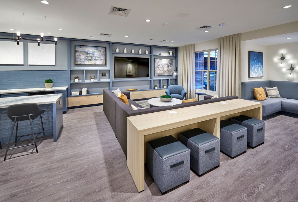 A modern living room with a bar area and a dining table.
