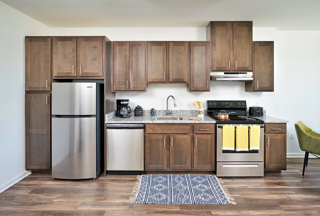 A modern kitchen with wooden cabinets and stainless steel appliances.