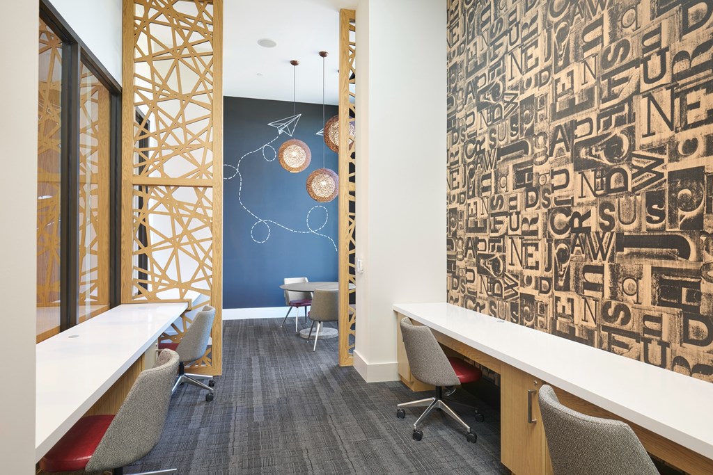 A room with a blue wall and a white table with chairs.