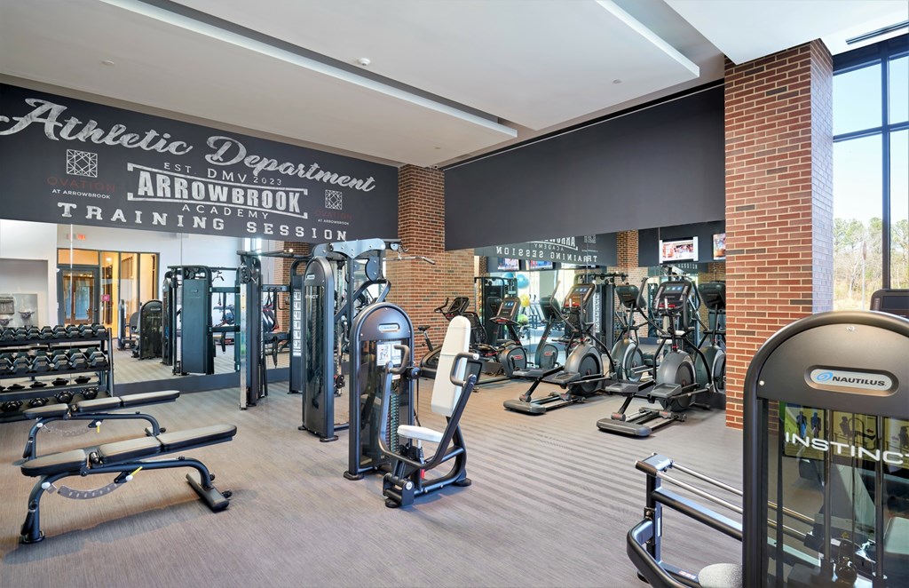 A gym with a sign that says "Athletic Department" and "Arrowbrook Training Session".