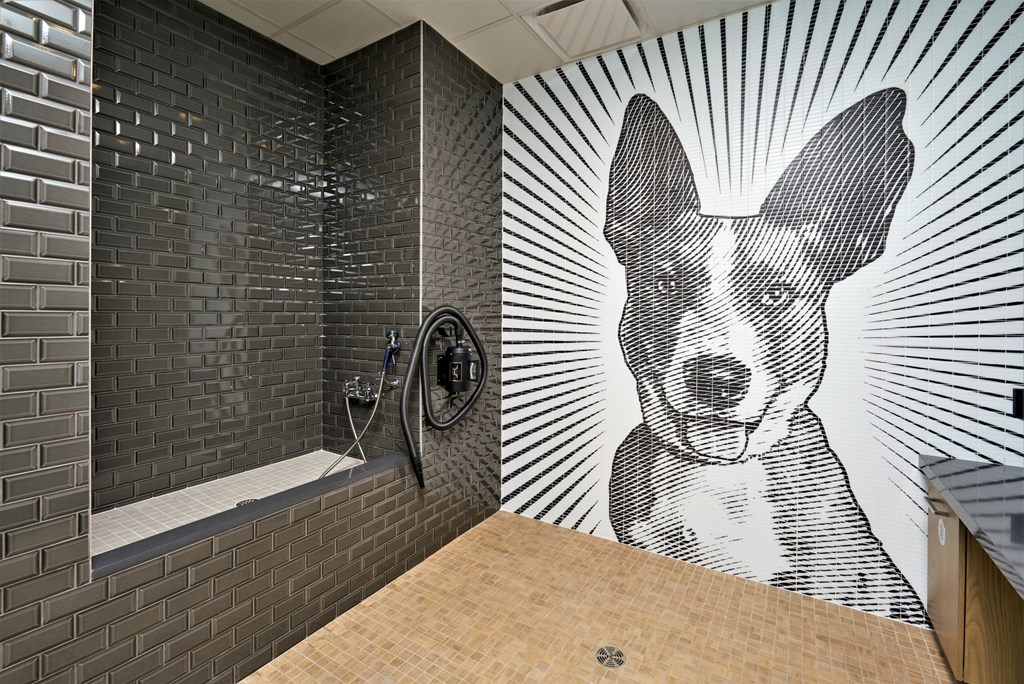A bathroom with a dog mural on the wall.