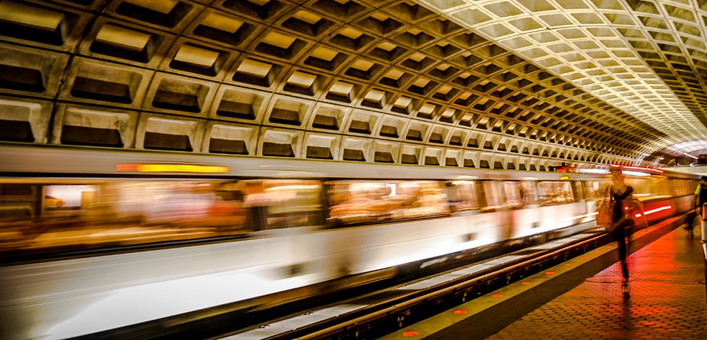 A subway train is passing through a subway station.