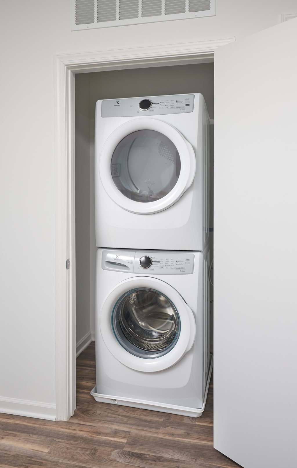 A white washing machine and dryer in a small room.