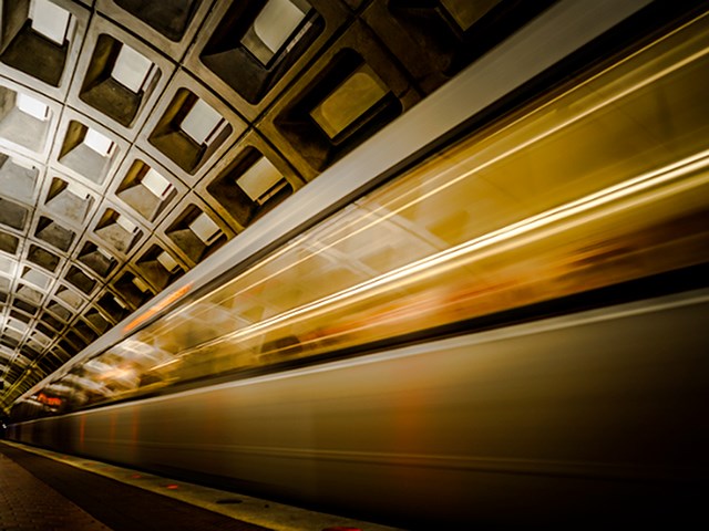 A train is passing through a subway station.