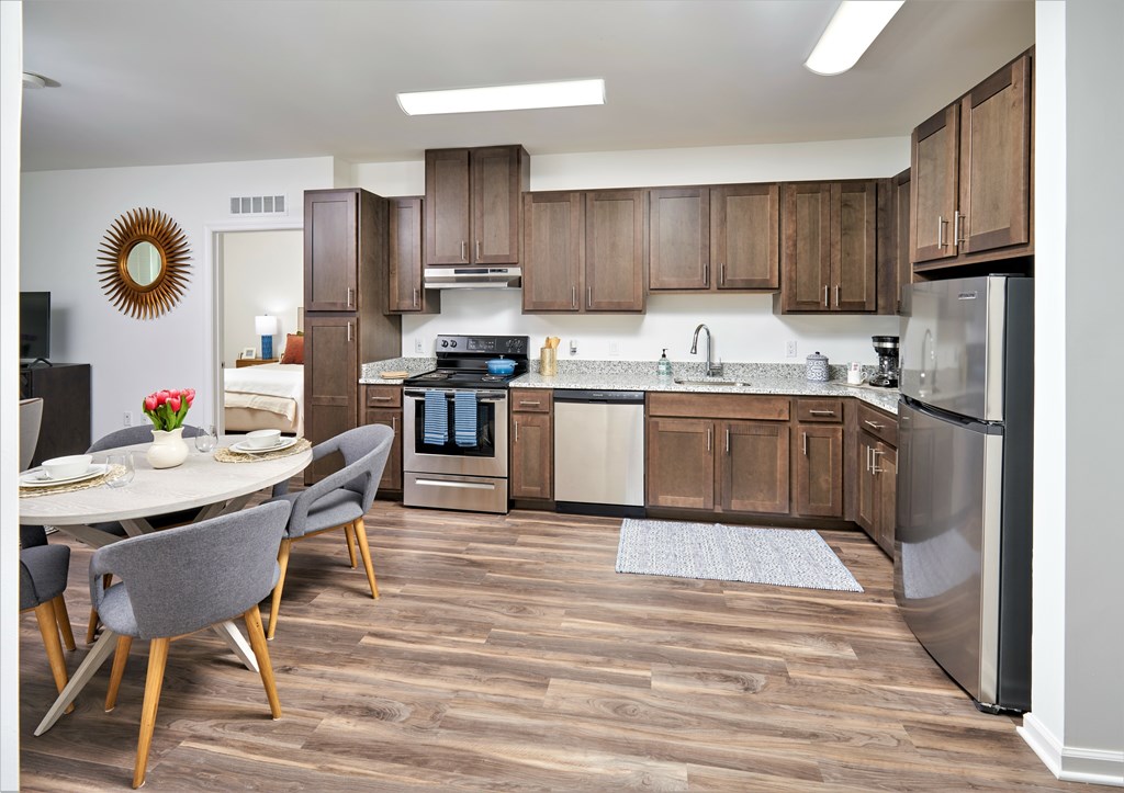 A modern kitchen with wooden cabinets and stainless steel appliances.