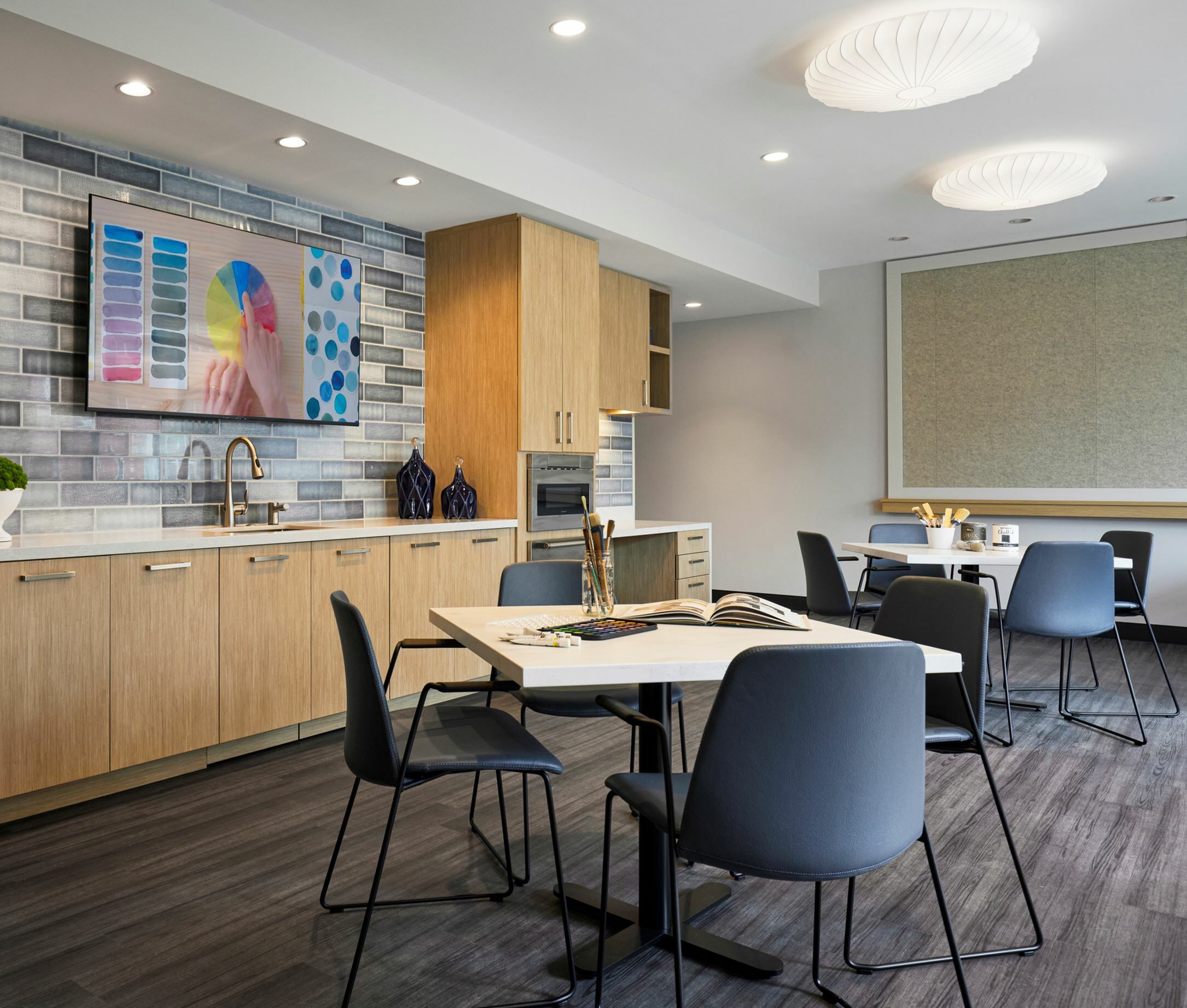 A modern kitchen with a dining table and chairs.
