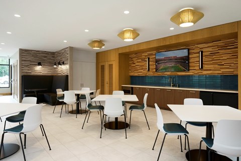 A modern dining room with white tables and chairs.