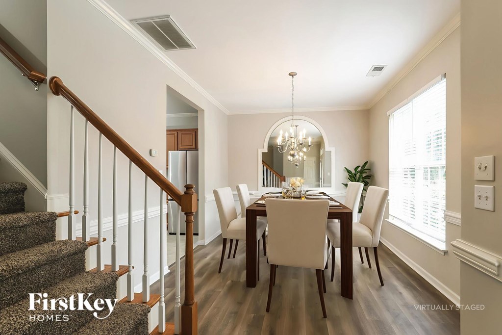 A dining room with a wooden table and chairs.