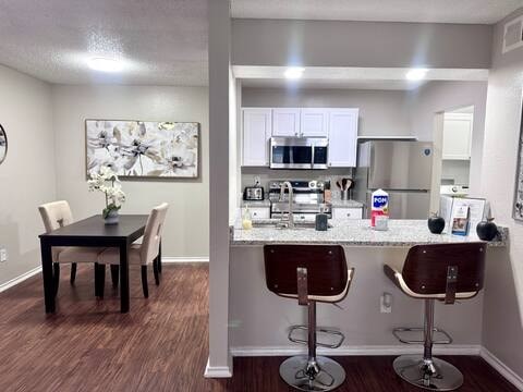 A kitchen with a dining table and chairs.