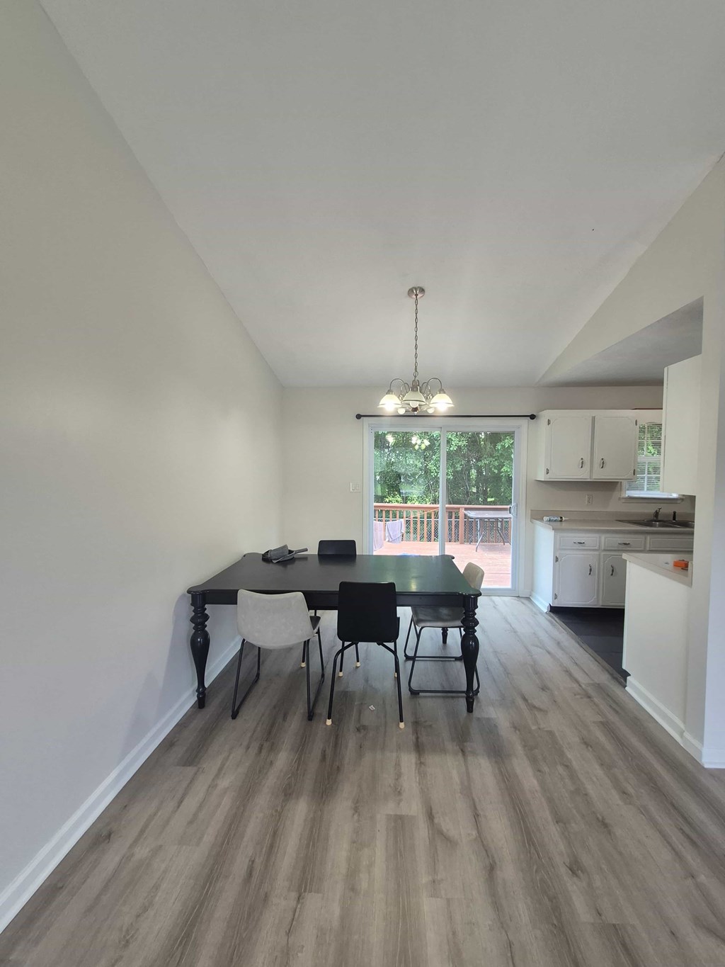 A dining room with a table and chairs.