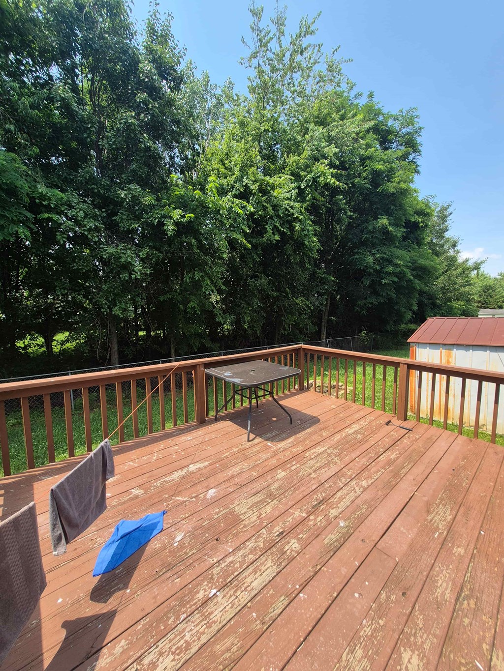 A wooden deck with a table and chairs.