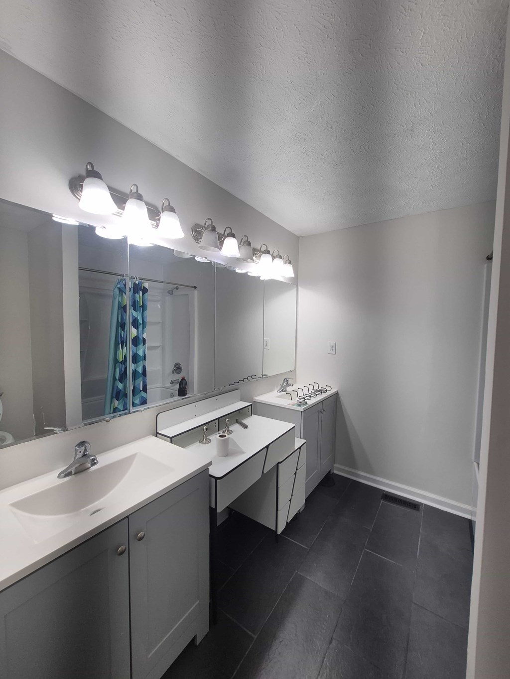 A bathroom with two sinks and a large mirror.