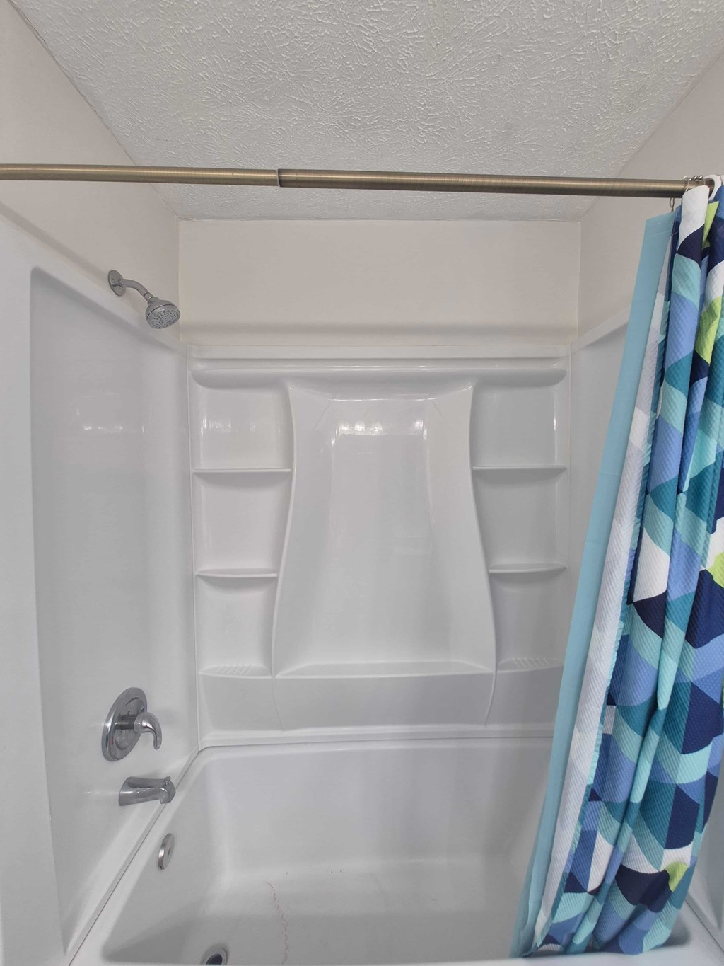 A white bathroom with a shower curtain.