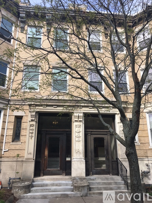 A large building with a tree in front of it.