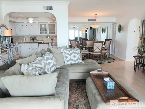 A living room with a grey couch and a coffee table.