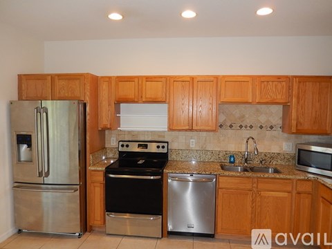 A kitchen with wooden cabinets and stainless steel appliances.