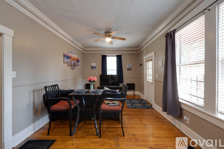 A dining room with a table and chairs.