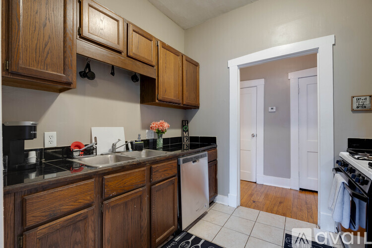 A kitchen with wooden cabinets and a white door.